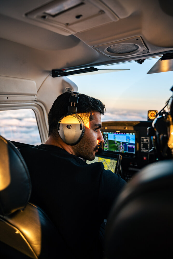 Pilot flying at sunset above the clouds